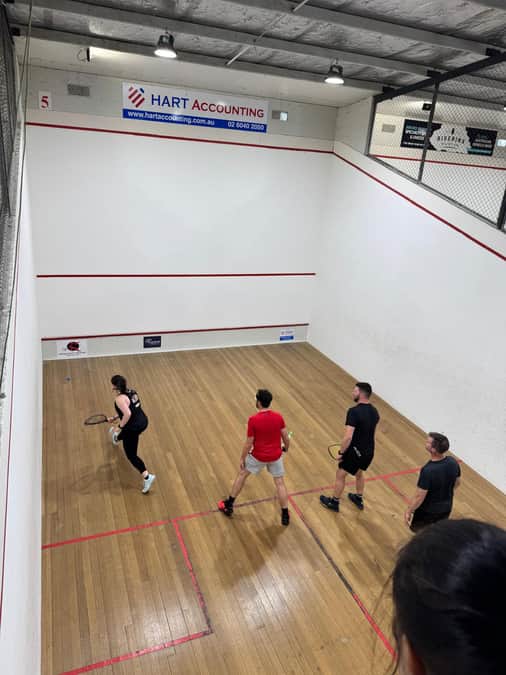 Members playing doubles racquetball on court at WSRA